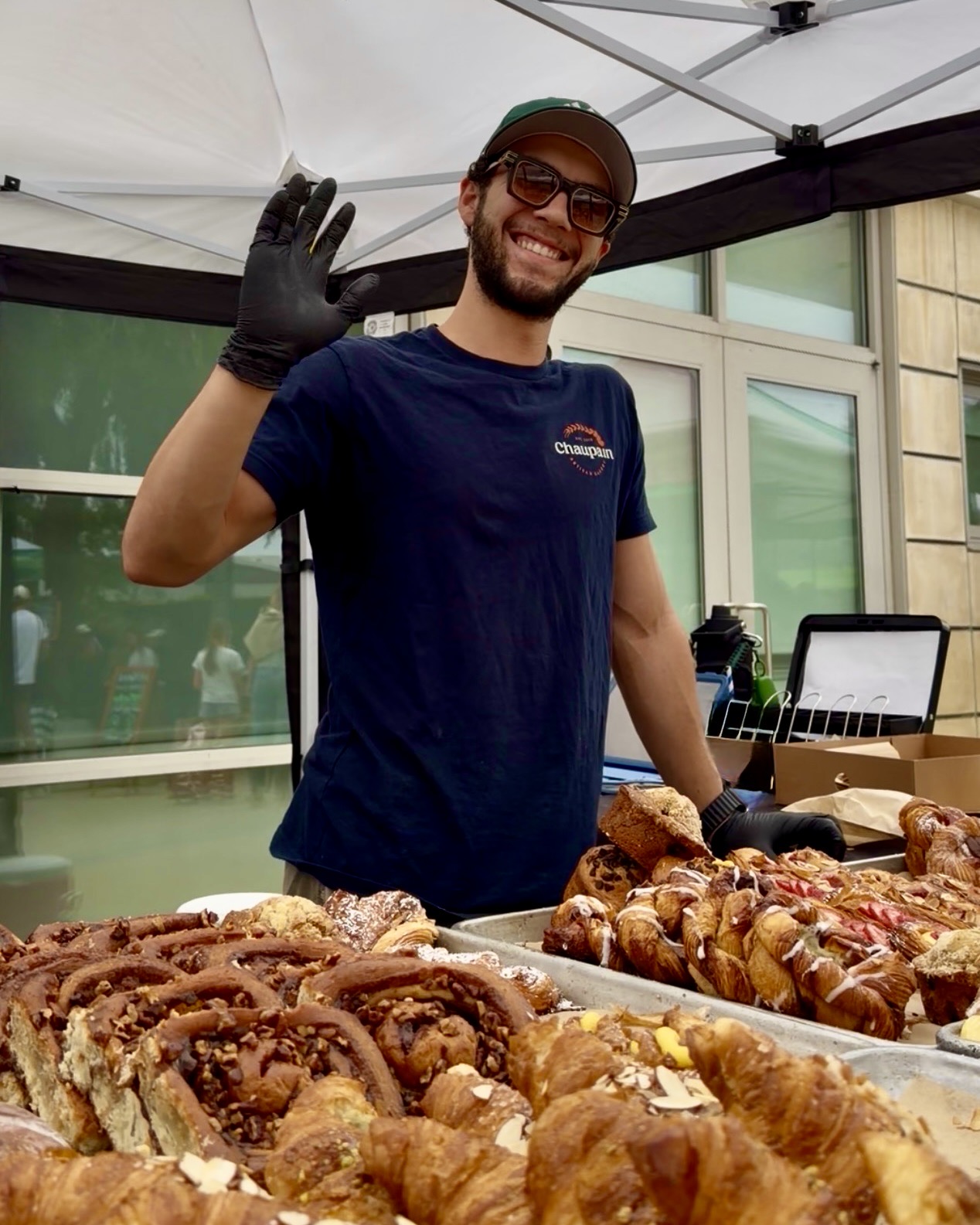 Chaupain Bakery Associate waving at camera